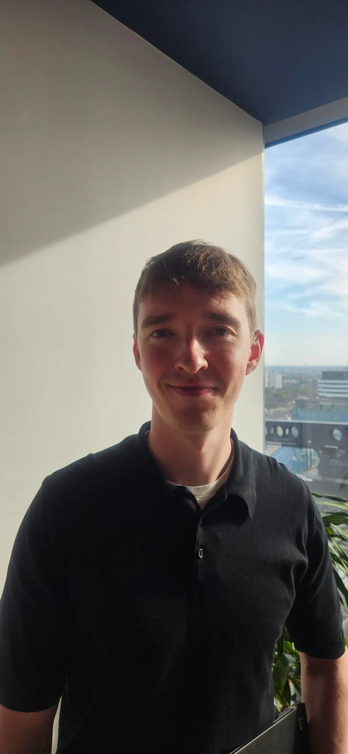 John, founder of My Trade Kit, standing by an office window.